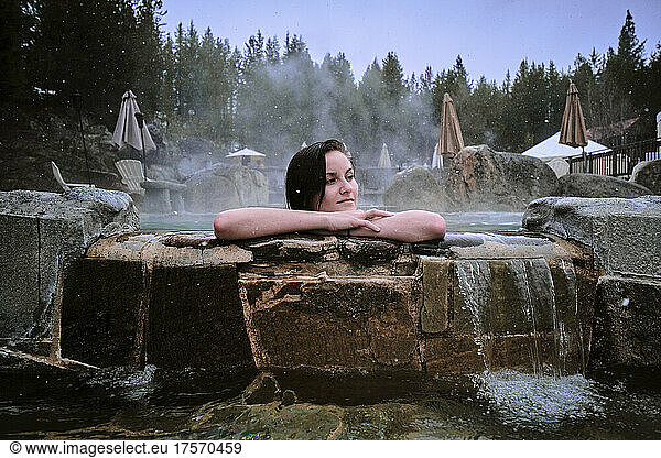 Young woman enjoys developed hot springs in an Idaho winter.