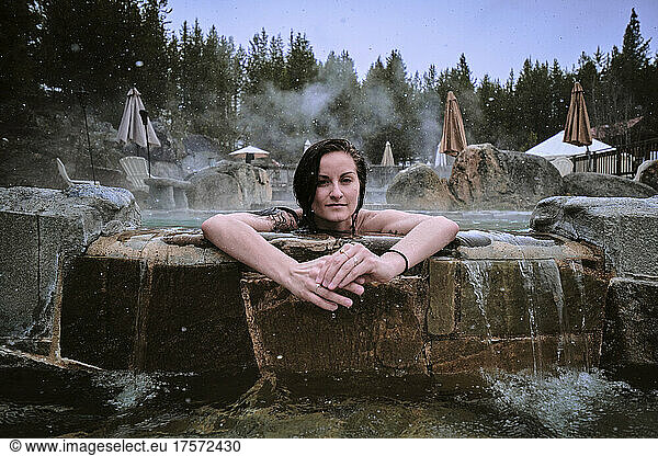 Young woman enjoys developed hot springs in an Idaho winter.