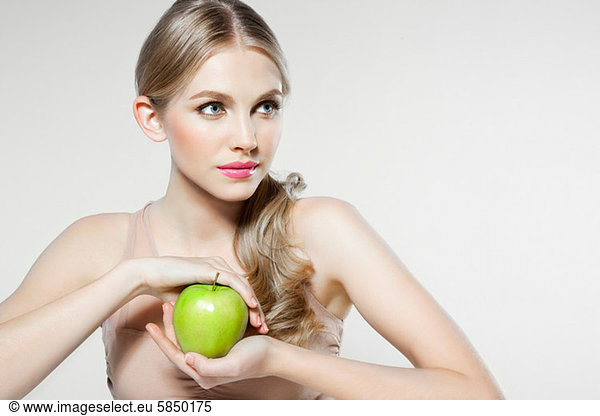 Young woman holding apple