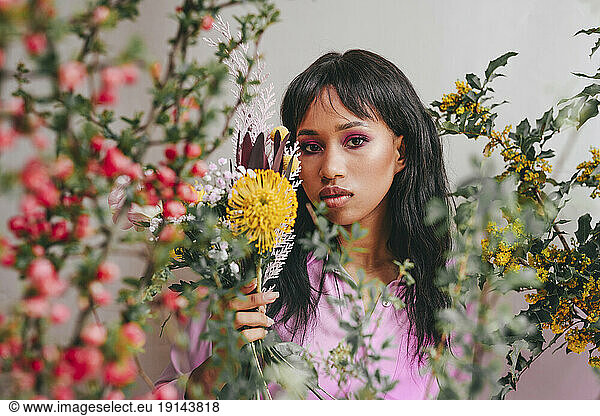 Young woman holding Leucospermum flower
