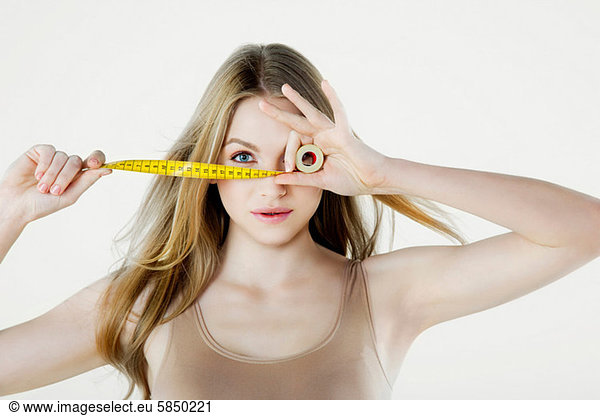 Young woman holding tape measure