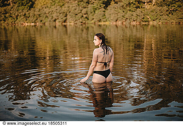 Young woman in a bikini standing in lake