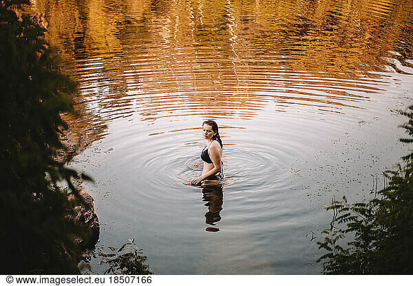 Young woman in a bikini standing in lake