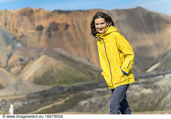 Young woman in a bright jacket on a sunny day in Iceland's highlands