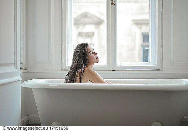 young woman in a vintage bathtub