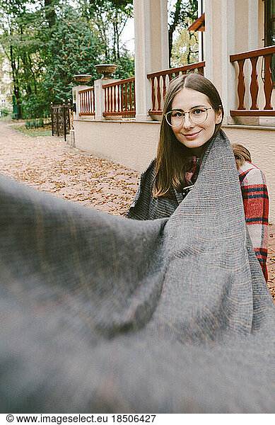 young woman in a warm coat in an autumn park