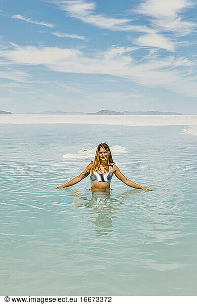 Young woman in bathing suit exploring the Bonneville Salt Flats.