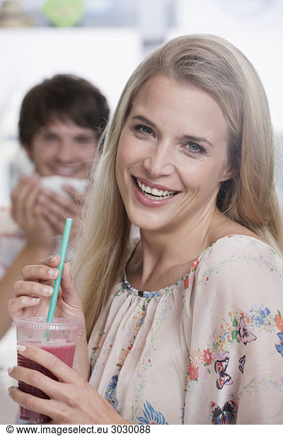 Young woman in cafe  man in background