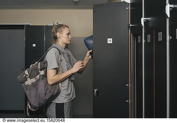 Young woman in locker room of a boxing club