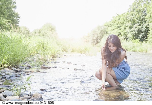 Young woman in shallow stream