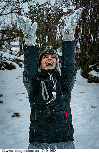 Young woman in snow smile play