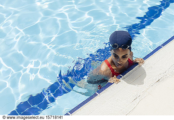 Young woman in swimming pool seen from above