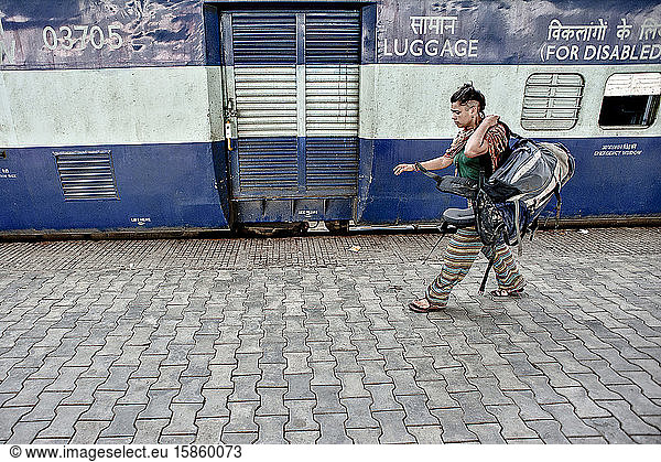Young woman in the train station backpacking in India