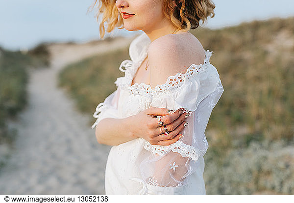 Young woman in white dress on coastal dunes  cropped  Menemsha  Martha's Vineyard  Massachusetts  USA