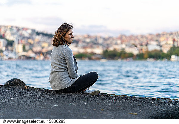 Young woman looking at Istanbul hills over Golden Horn