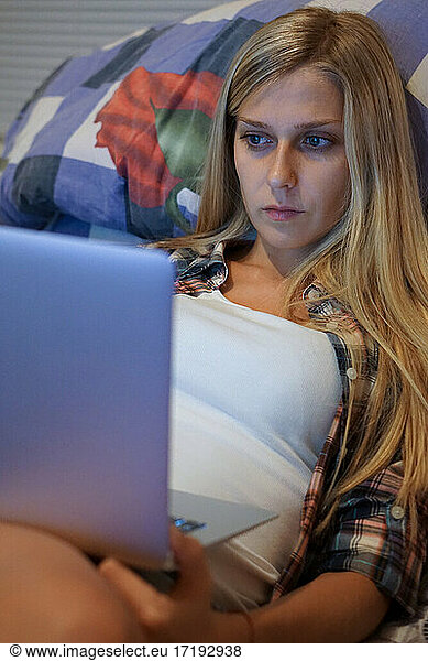 young woman looking at laptop