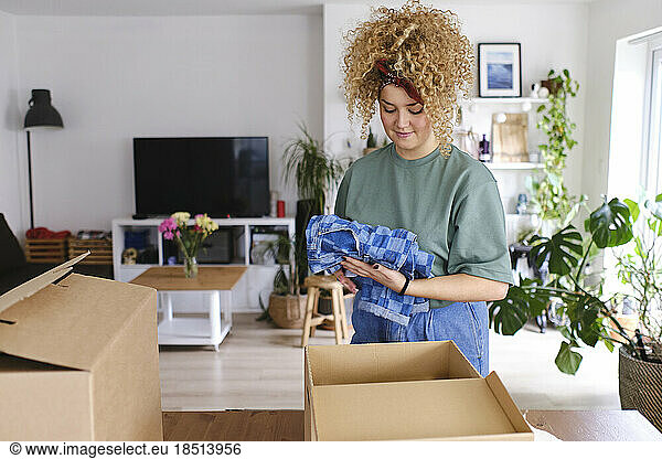 Young woman packing order in box