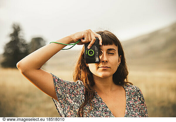 Young woman photographing through camera