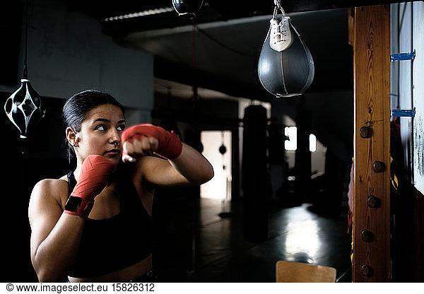 young woman practicing boxing at the gym