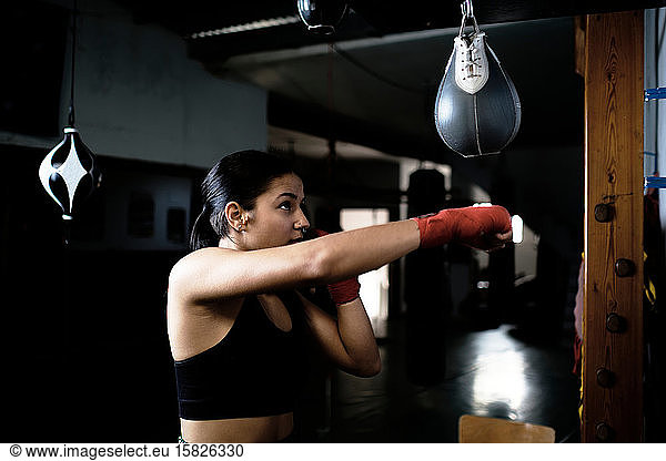 young woman practicing boxing at the gym