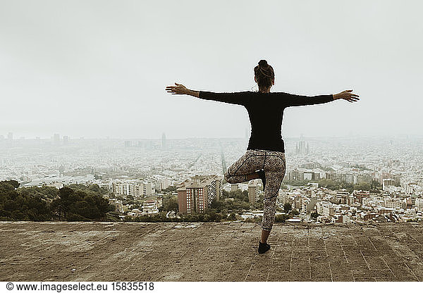 Young woman practicing yoga  asana with arms crossed. Barcelona