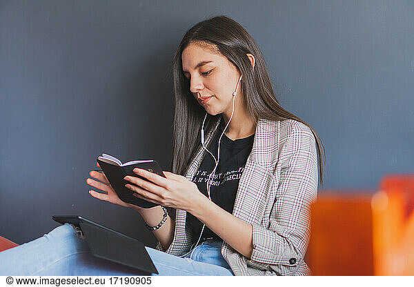 Young woman reading an electronic book.