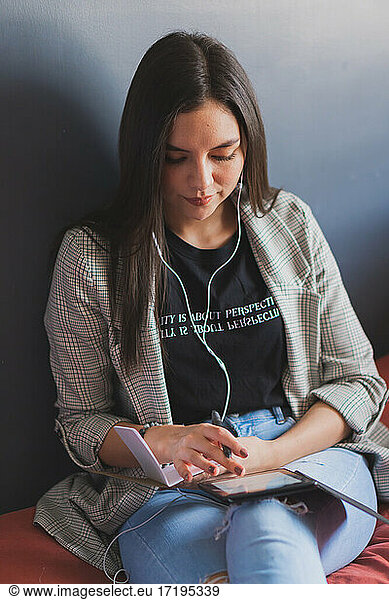 Young woman reading an electronic book.