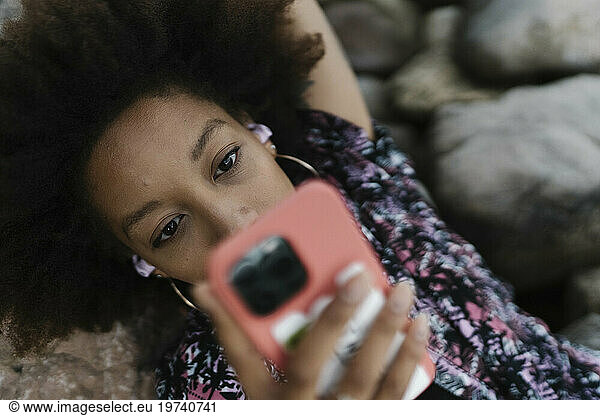 Young woman relaxing and using mobile phone