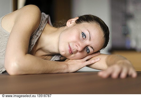 Young woman resting her head on her arm
