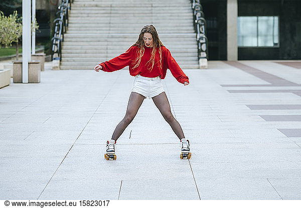 Young woman roller skating in the city