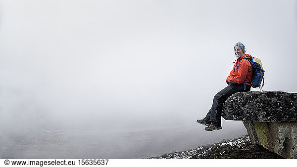 Young woman sitting on rock spur near Dinboche  Solo Khumbu  Nepal