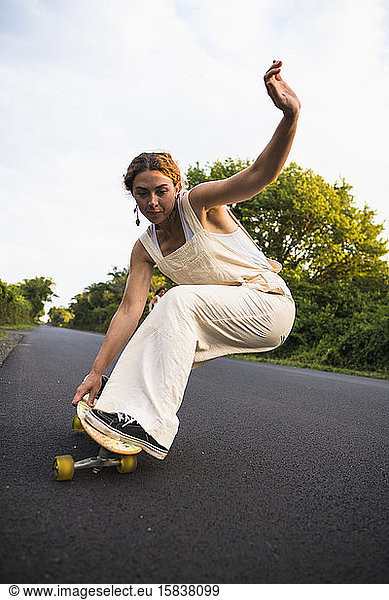 Young Woman Skateboarding in Summer