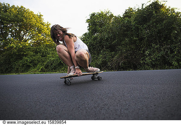 Young Woman Skateboarding in Summer