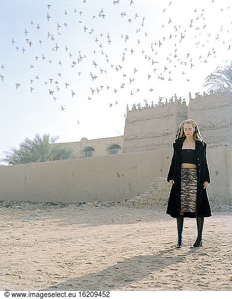 Young woman standing in front of a building