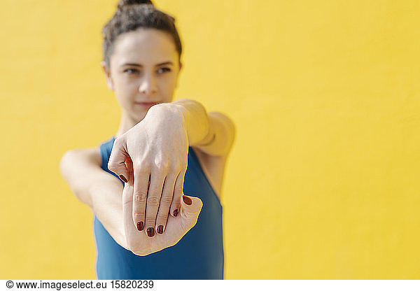 Young woman stretching her hands