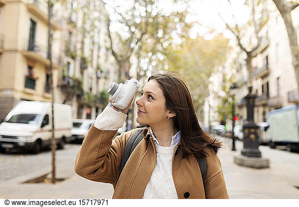 Young woman taking pictures in the city  Barcelona  Spain