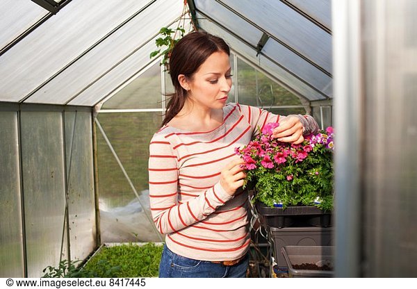 Young woman tending plants