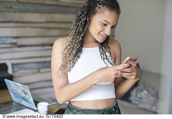 Young woman texting with smart phone