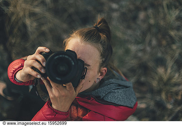 Young woman using camera