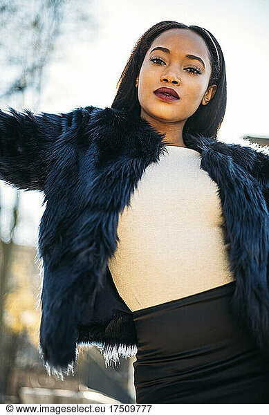 Young woman wearing fur jacket outdoors