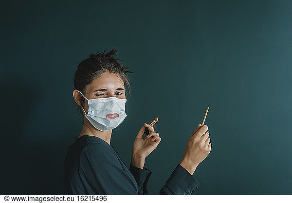 Young Woman Wearing Mask With Makeup