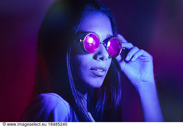 Young woman wearing steampunk glasses