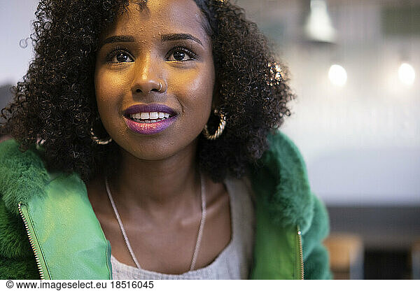 Young woman with curly hair wearing nose ring