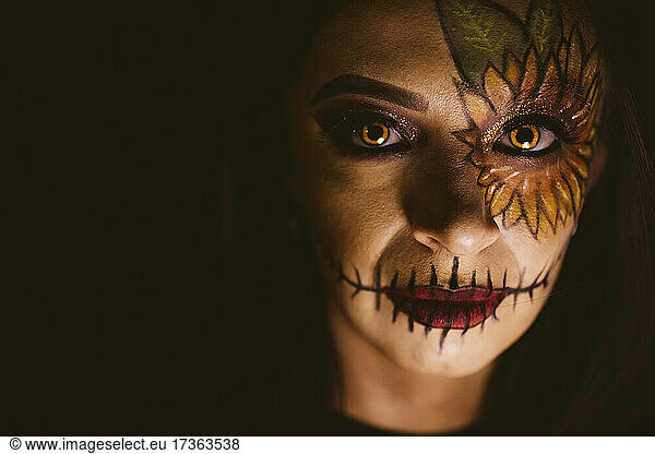 Young woman with evil make-up during Halloween