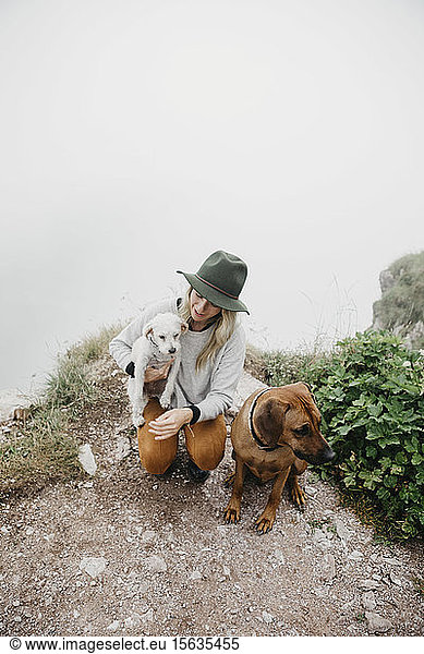 Young woman with two dogs on viewpoint