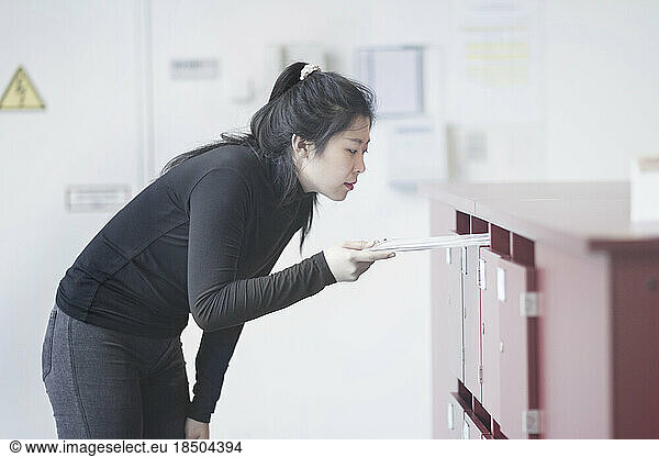 Young woman working at reception in office  Freiburg im Breisgau  Baden-Württemberg  Germany