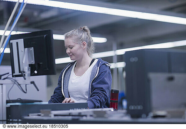 Young woman working in books printing industry  Bremgarten  Hartheim am Rhein  Baden-Wuerttemberg  Germany