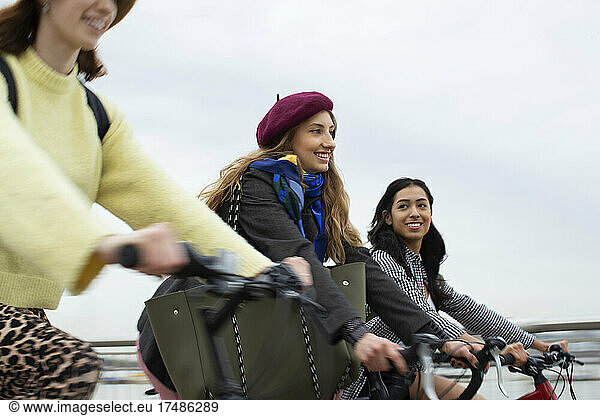 Young women friends riding bicycles
