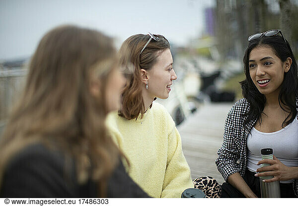Young women friends talking