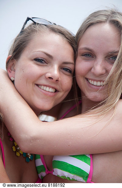 Young women hugging and smiling  close up